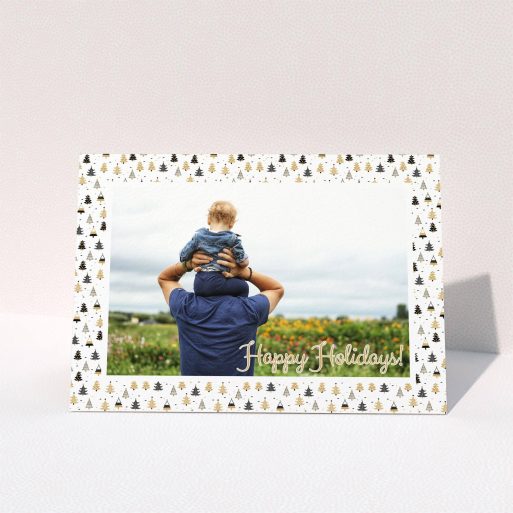 A family christmas card named "Golden Winter Forrest". It is an A6 card in a landscape orientation. It is a photographic family christmas card with room for 1 photo. "Golden Winter Forrest" is available as a folded card, with tones of white, gold and black.