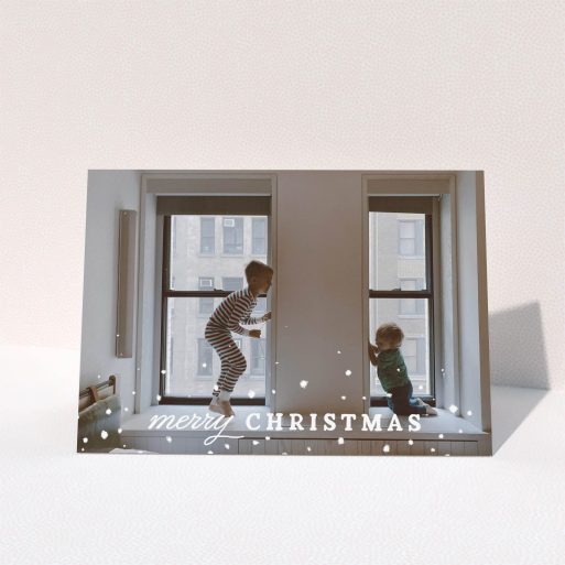 A family christmas card design called "Handdrawn". It is an A5 card in a landscape orientation. It is a photographic family christmas card with room for 1 photo. "Handdrawn" is available as a folded card, with mainly white colouring.