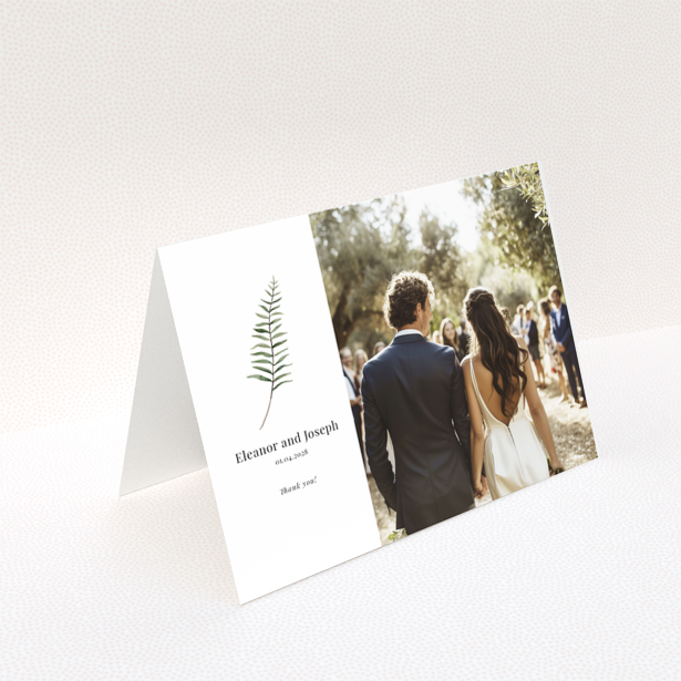 Elegant wedding invitation with a botanical design and one photo of a couple.