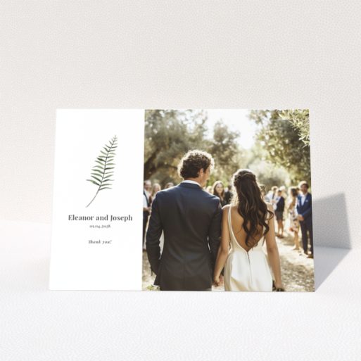 Elegant wedding invitation with a botanical design and one photo of a couple.