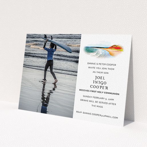 A first holy communion invitation design named 'Watercolour Bay'. It is an A6 invite in a landscape orientation. It is a photographic first holy communion invitation with room for 1 photo. 'Watercolour Bay' is available as a flat invite, with tones of white, orange and light blue.