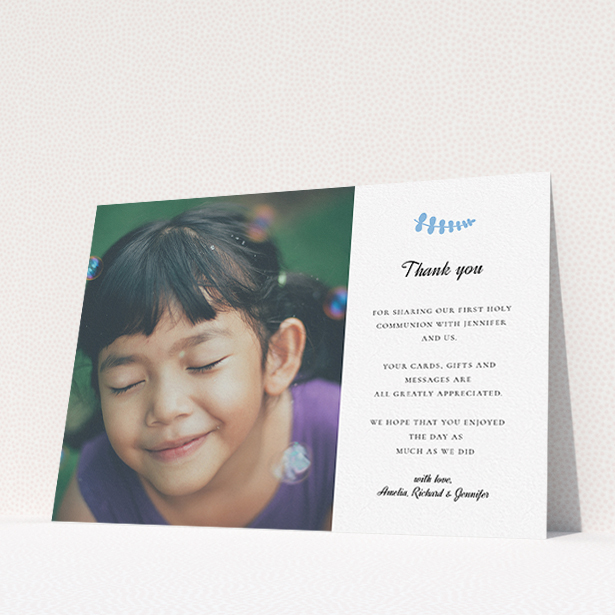 A first holy communion thank you card called "Blue Fern". It is an A5 card in a landscape orientation. It is a photographic first holy communion thank you card with room for 1 photo. "Blue Fern" is available as a flat card, with tones of white and blue.