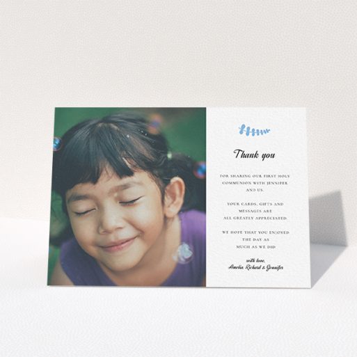 A first holy communion thank you card design called "Blue Fern". It is an A6 card in a landscape orientation. It is a photographic first holy communion thank you card with room for 1 photo. "Blue Fern" is available as a folded card, with tones of white and blue.