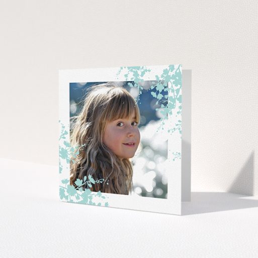 A first holy communion thank you card called 'Blue Forest Corners'. It is a square (148mm x 148mm) card in a square orientation. It is a photographic first holy communion thank you card with room for 1 photo. 'Blue Forest Corners' is available as a folded card, with tones of green and white.