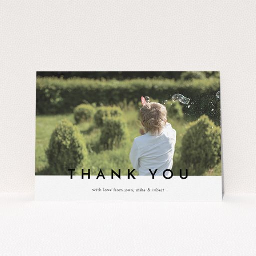 A first holy communion thank you card design called "Cross Border". It is an A5 card in a landscape orientation. It is a photographic first holy communion thank you card with room for 1 photo. "Cross Border" is available as a flat card, with mainly white colouring.