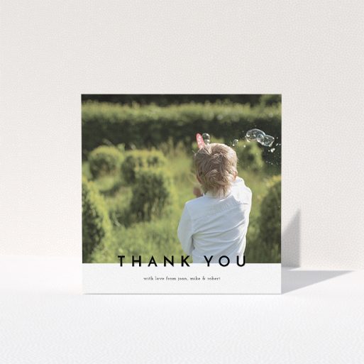 A first holy communion thank you card template titled "Cross Border". It is a square (148mm x 148mm) card in a square orientation. It is a photographic first holy communion thank you card with room for 1 photo. "Cross Border" is available as a folded card, with mainly white colouring.