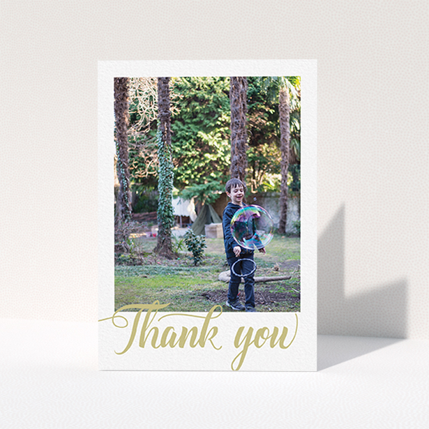A first holy communion thank you card design called "Golden Thank You". It is an A6 card in a portrait orientation. It is a photographic first holy communion thank you card with room for 1 photo. "Golden Thank You" is available as a folded card, with tones of cream and gold.