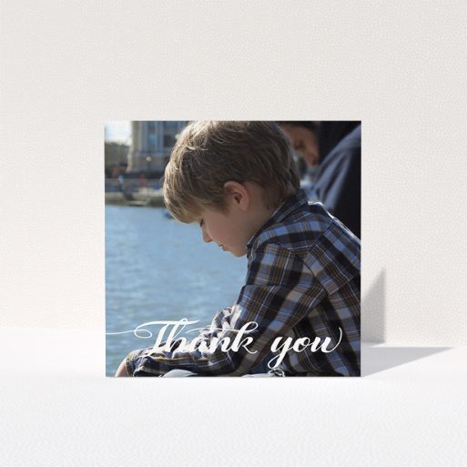 A first holy communion thank you card design named "Handwritten Italic". It is a square (148mm x 148mm) card in a square orientation. It is a photographic first holy communion thank you card with room for 1 photo. "Handwritten Italic" is available as a folded card, with mainly white colouring.