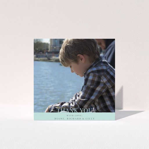 First Holy Communion Thank You Card Design - "Mint Blue Bottom Banner" A first holy communion thank you card design named "Mint Blue Bottom Banner". It is a square (148mm x 148mm) card in a square orientation. It is a photographic first holy communion thank you card with room for 1 photo. "Mint Blue Bottom Banner" is available as a folded card, with mainly blue colouring.