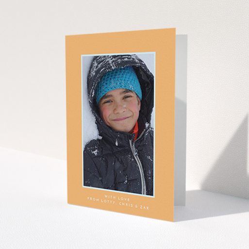 A first holy communion thank you card named 'Orange and Mint'. It is an A6 card in a portrait orientation. It is a photographic first holy communion thank you card with room for 1 photo. 'Orange and Mint' is available as a folded card, with tones of orange and blue.