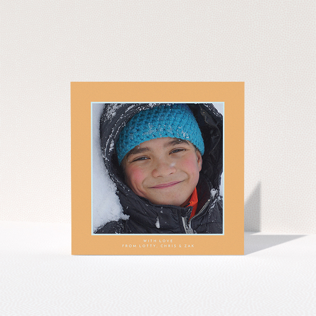 A first holy communion thank you card named "Orange and Mint". It is a square (148mm x 148mm) card in a square orientation. It is a photographic first holy communion thank you card with room for 1 photo. "Orange and Mint" is available as a folded card, with tones of orange and blue.