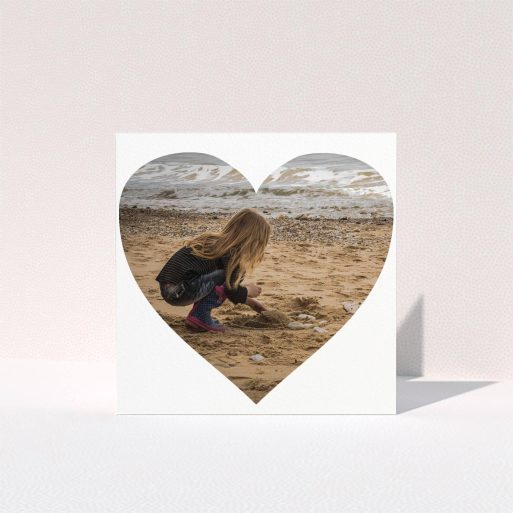 First Holy Communion Thank You Card Design - "Simple Heart Frames" A first holy communion thank you card called "Simple Heart Frames". It is a square (148mm x 148mm) card in a square orientation. It is a photographic first holy communion thank you card with room for 1 photo. "Simple Heart Frames" is available as a folded card, with mainly white colouring.