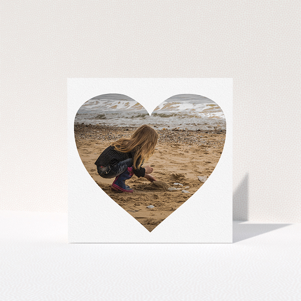 A first holy communion thank you card called "Simple Heart Frames". It is a square (148mm x 148mm) card in a square orientation. It is a photographic first holy communion thank you card with room for 1 photo. "Simple Heart Frames" is available as a folded card, with mainly white colouring.
