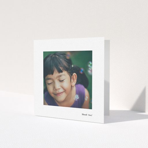 A first holy communion thank you card named 'Thank You!'. It is a square (148mm x 148mm) card in a square orientation. It is a photographic first holy communion thank you card with room for 1 photo. 'Thank You!' is available as a folded card, with mainly white colouring.