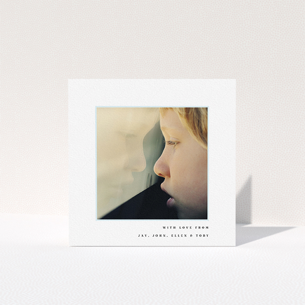 A first holy communion thank you card design titled "Thin Blue Frame". It is a square (148mm x 148mm) card in a square orientation. It is a photographic first holy communion thank you card with room for 1 photo. "Thin Blue Frame" is available as a folded card, with mainly white colouring.