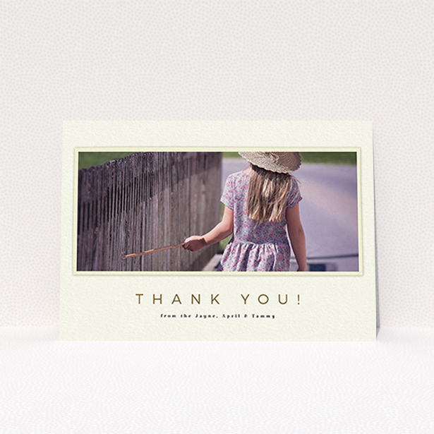 A first holy communion thank you card design titled "Torn Cream Frame". It is an A6 card in a landscape orientation. It is a photographic first holy communion thank you card with room for 1 photo. "Torn Cream Frame" is available as a flat card, with mainly cream colouring.