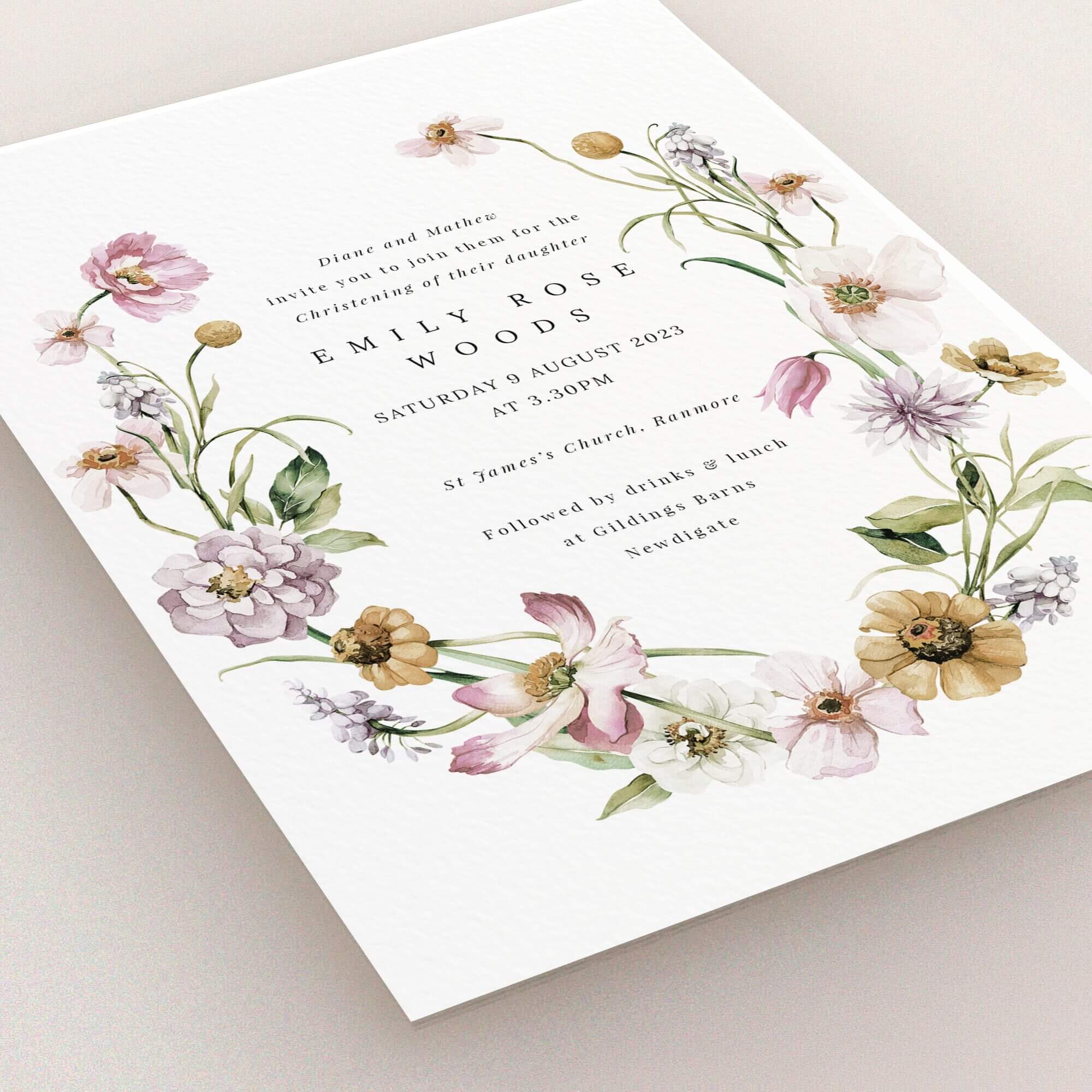 Floral christening invitation design with two images of floral arrangements.