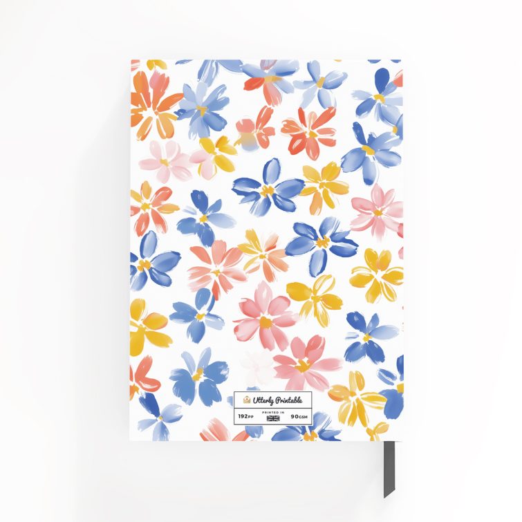 Colourful floral design on a personalised notebook cover spread from Utterly Printable with two photos.