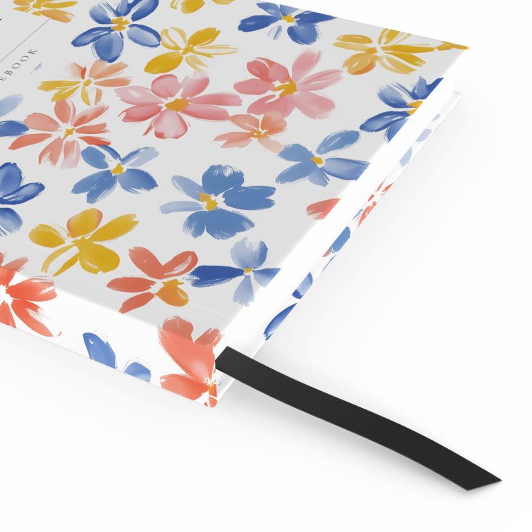 Colourful floral design on a personalised notebook cover spread from Utterly Printable with two photos.