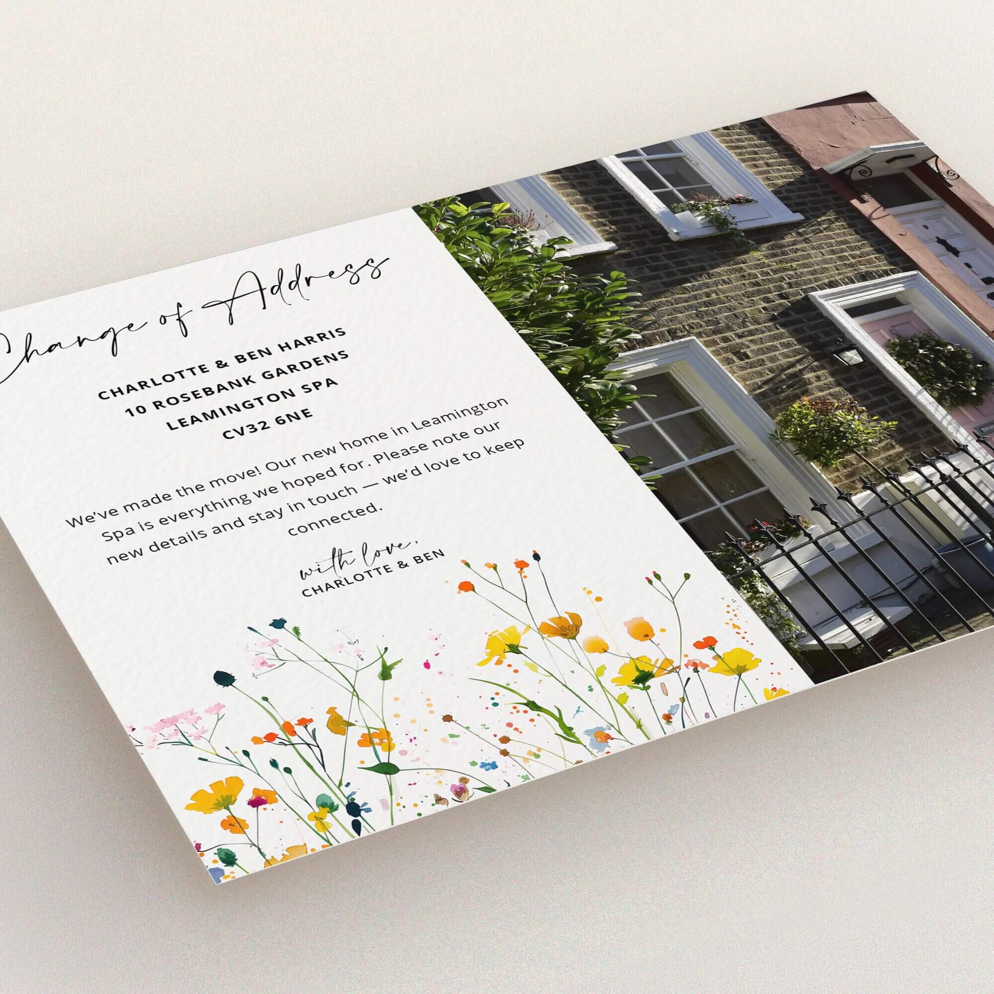 Floral change of address card design with two-storey house photo on the right side.