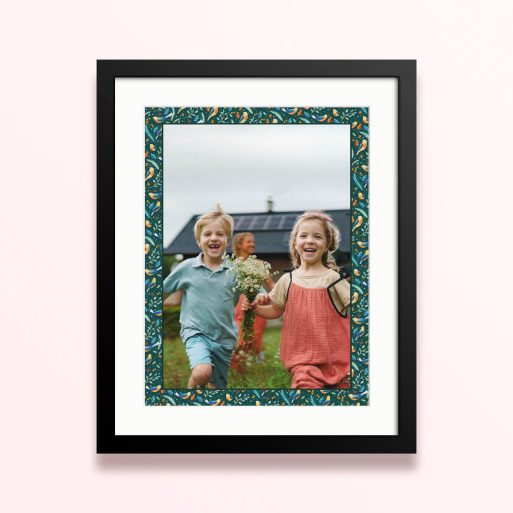 Framed and mounted photo print with two children running and holding a bouquet of flowers.