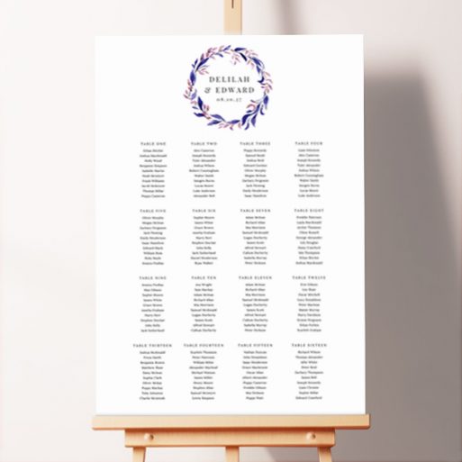 Romantic and whimsical wedding seating plan featuring a gorgeous floral wreath in shades of blue and purple surrounding the couple's names at the top of the board.. This one shows 16 tables.