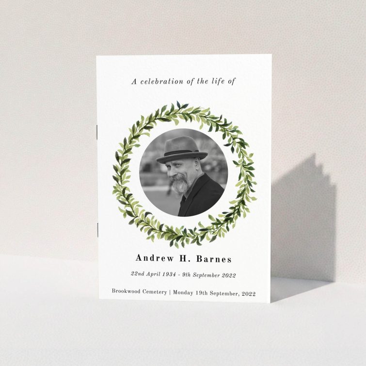 A funeral order of service named "Solemn wreath. It is an A5 booklet in a portrait orientation. It is a photographic funeral program with room for 1 photo. "Solemn wreath" is available as a folded booklet booklet, with tones of white and green.