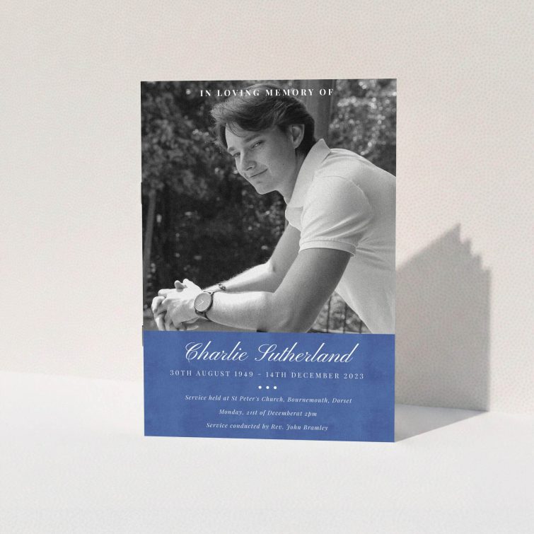 A funeral order of service named "Bold Elegance. It is an A5 booklet in a portrait orientation. It is a photographic funeral program with room for 1 photo. "Bold Elegance" is available as a folded booklet booklet, with splashes of navy blue.