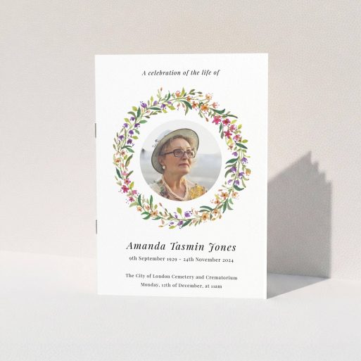 A funeral order of service named "Bright Florals. It is an A5 booklet in a portrait orientation. It is a photographic funeral program with room for 1 photo. "Bright Florals" is available as a folded booklet booklet, with tones of yellow, light pink and orange.