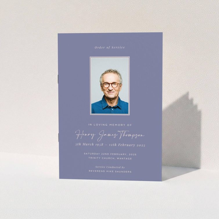 Purple and white funeral order of service program with one photo of an elderly man wearing glasses.