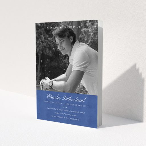 A funeral order of service named 'Bold Elegance. It is an A5 booklet in a portrait orientation. It is a photographic funeral program with room for 1 photo. 'Bold Elegance' is available as a folded booklet booklet, with splashes of navy blue.
