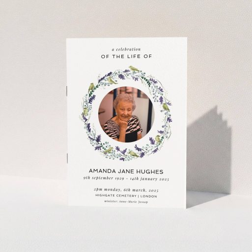 A funeral order of service named "Bird wreath. It is an A5 booklet in a portrait orientation. It is a photographic funeral program with room for 1 photo. "Bird wreath" is available as a folded booklet booklet, with tones of green and purple.