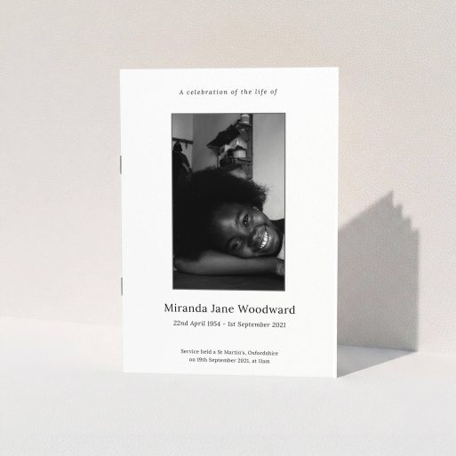 A funeral order of service named "Simple Silver. It is an A5 booklet in a portrait orientation. It is a photographic funeral program with room for 1 photo. "Simple Silver" is available as a folded booklet booklet, with tones of white, grey and black.