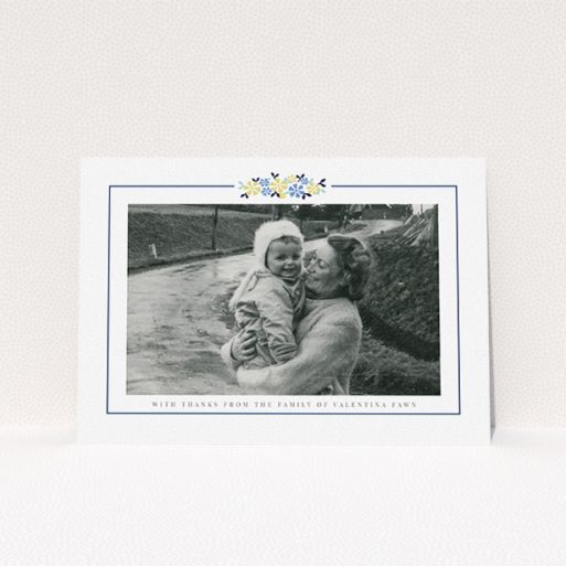 A funeral thank you card design titled "Remembered in flowers". It is an A5 card in a landscape orientation. It is a photographic funeral thank you card with room for 1 photo. "Remembered in flowers" is available as a flat card, with tones of white and blue.