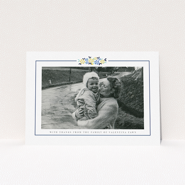 A funeral thank you card design titled "Remembered in flowers". It is an A5 card in a landscape orientation. It is a photographic funeral thank you card with room for 1 photo. "Remembered in flowers" is available as a flat card, with tones of white and blue.