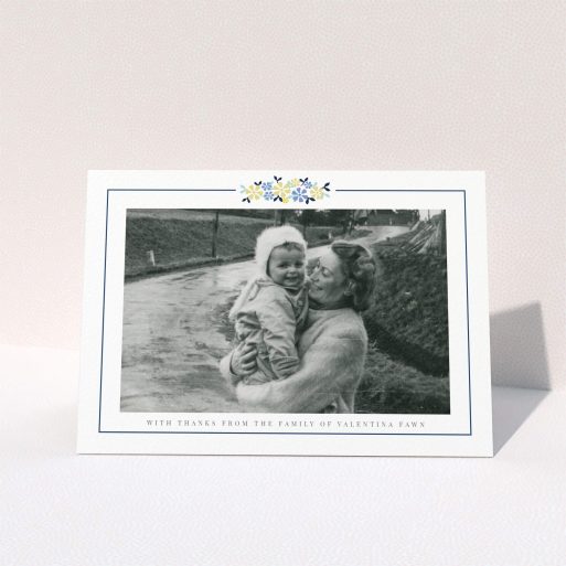 Funeral Thank You Card Design - "Remembered in flowers" A funeral thank you card called "Remembered in flowers". It is an A6 card in a landscape orientation. It is a photographic funeral thank you card with room for 1 photo. "Remembered in flowers" is available as a folded card, with tones of white and blue.