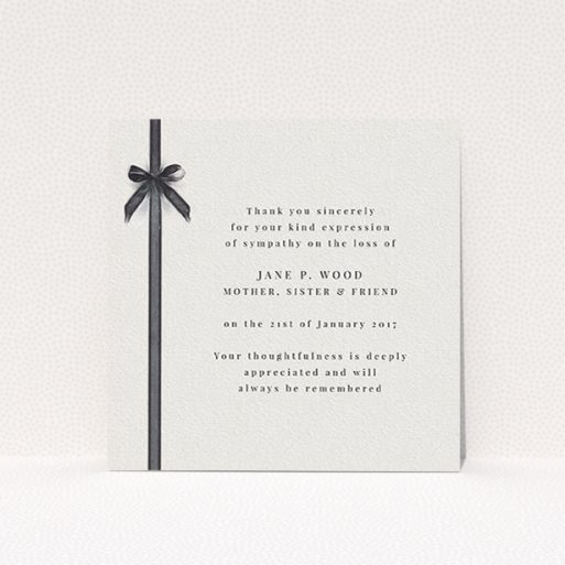 A funeral thank you card design named "Tied gracefully". It is a square (148mm x 148mm) card in a square orientation. "Tied gracefully" is available as a flat card, with tones of pale cream and faded black.
