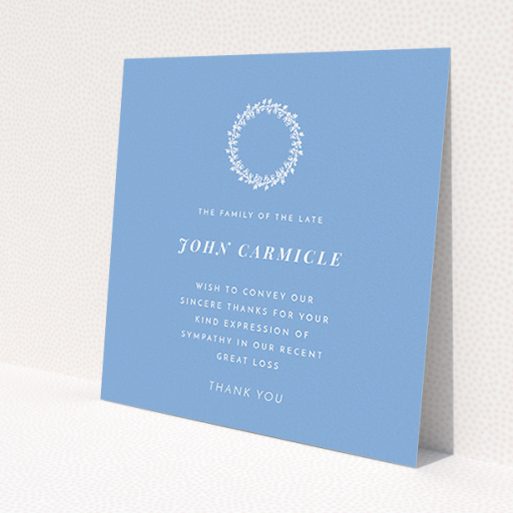 A funeral thank you card design named 'White Wreath in Blue'. It is a square (148mm x 148mm) card in a square orientation. 'White Wreath in Blue' is available as a flat card, with tones of blue and white.