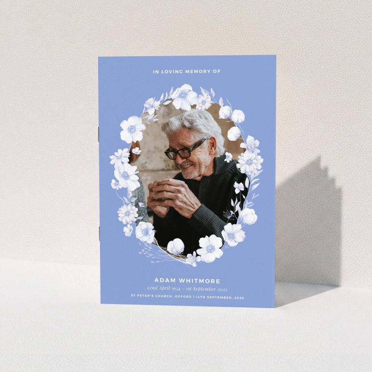 Floral funeral order of service program design with one photo and blue background.