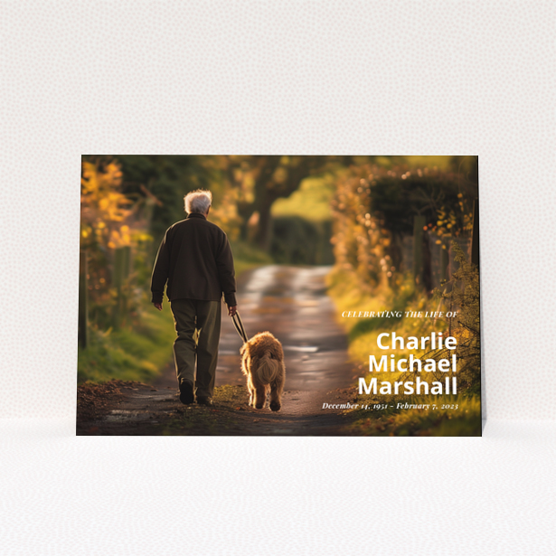 Funeral announcement card with a photo of a man walking a dog along a path with autumn foliage.