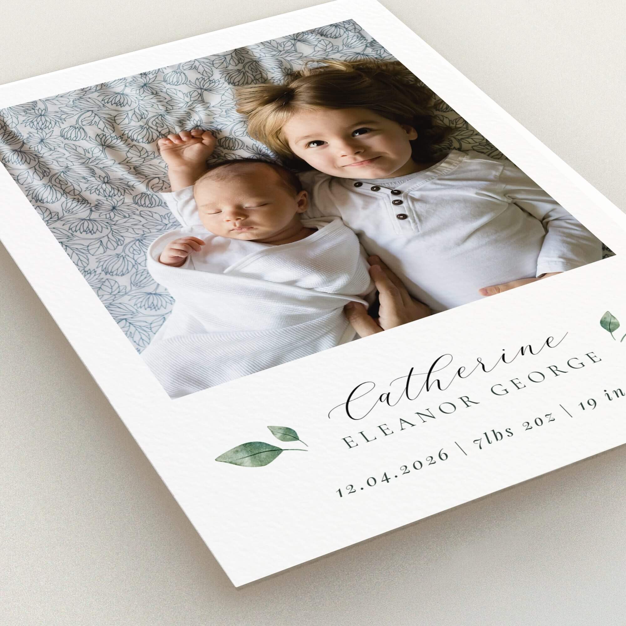 Two-photo birth announcement card design with floral accents and elegant typography.