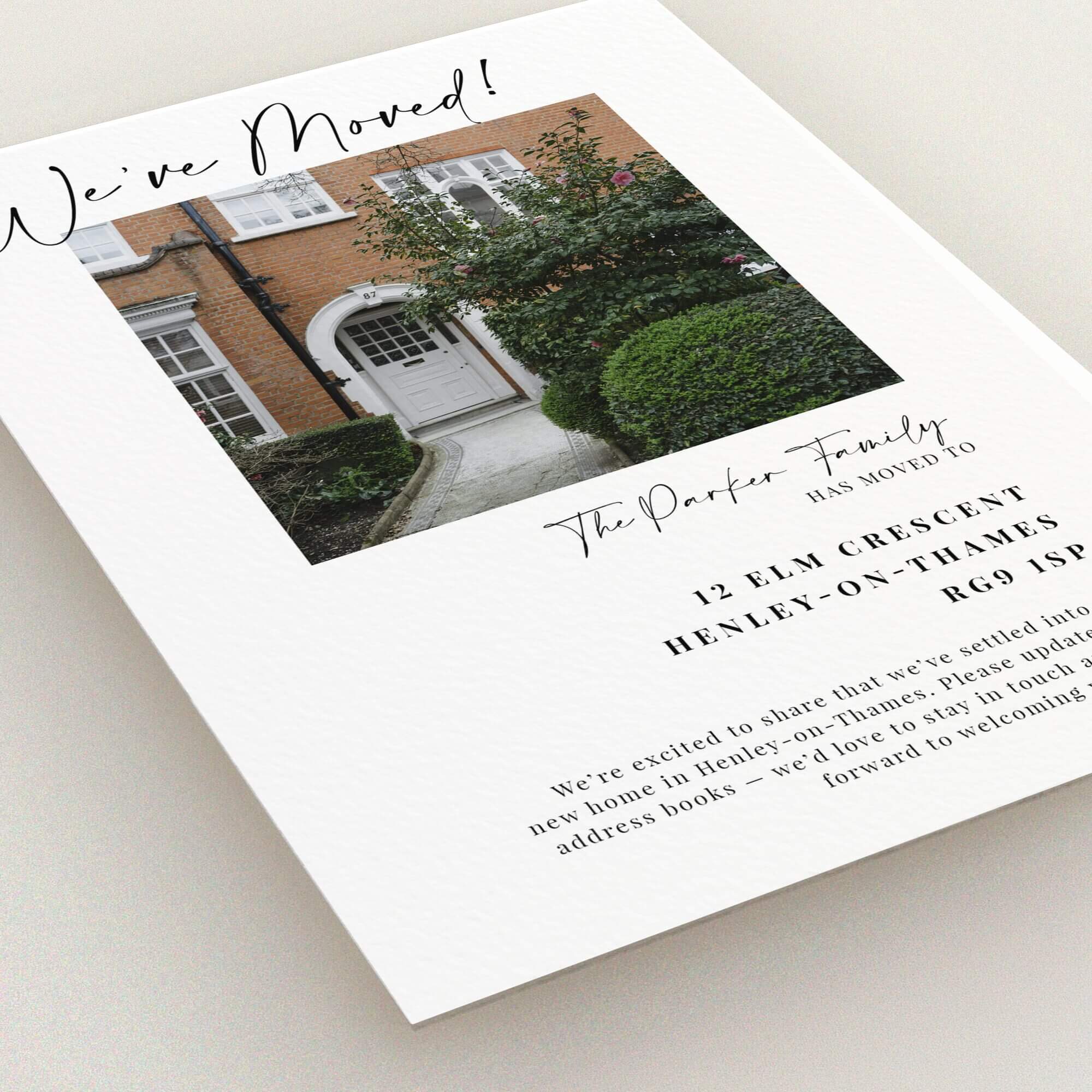 Elegant change of address card design with photo of new home exterior.