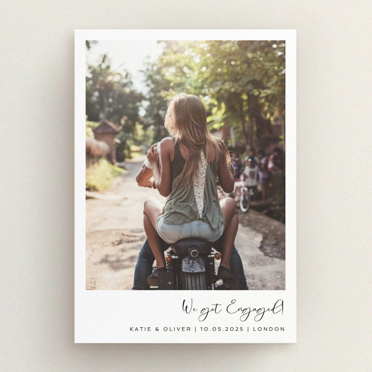 Engagement party invitations with a romantic photo of a couple riding a motorcycle