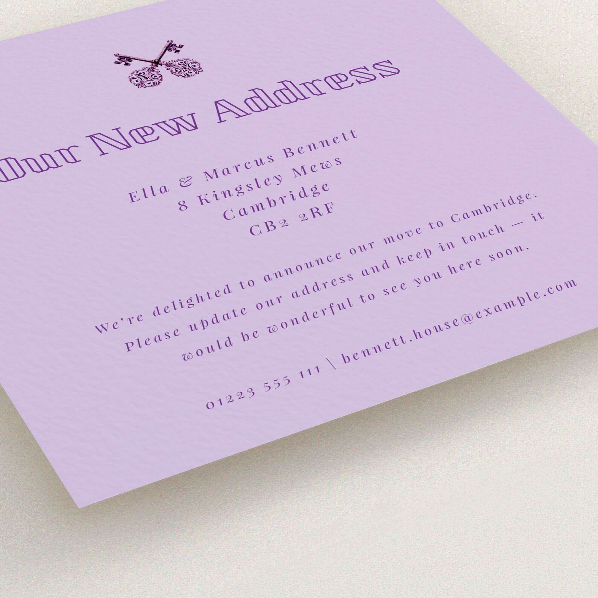 Elegant lavender change of address card design featuring vintage key graphic.