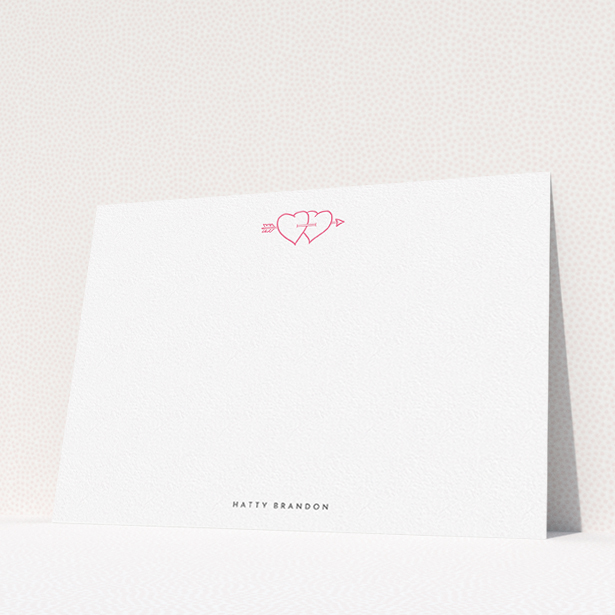 A ladies personalised note card design titled "Arrow through the hearts". It is an A5 card in a landscape orientation. "Arrow through the hearts" is available as a flat card, with tones of white and pink.