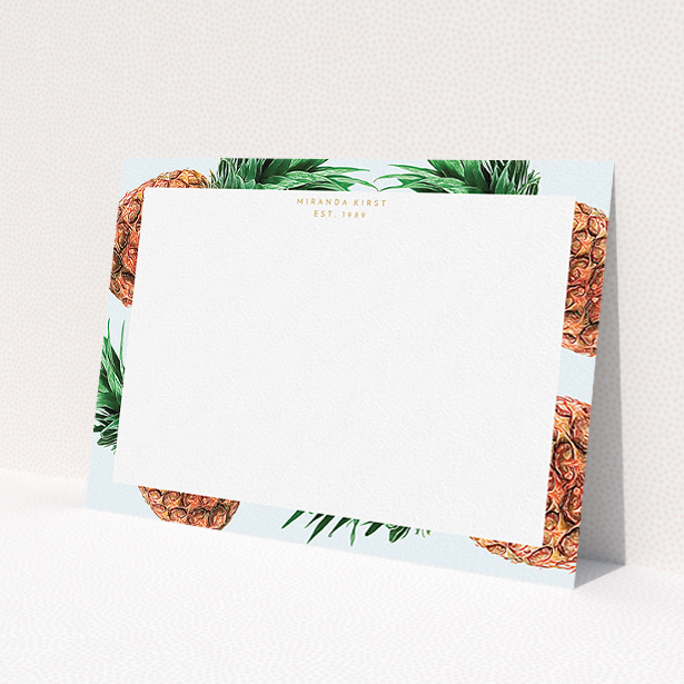 A ladies personalised note card design called "Falling pineapples". It is an A5 card in a landscape orientation. "Falling pineapples" is available as a flat card, with tones of light blue, green and brown.