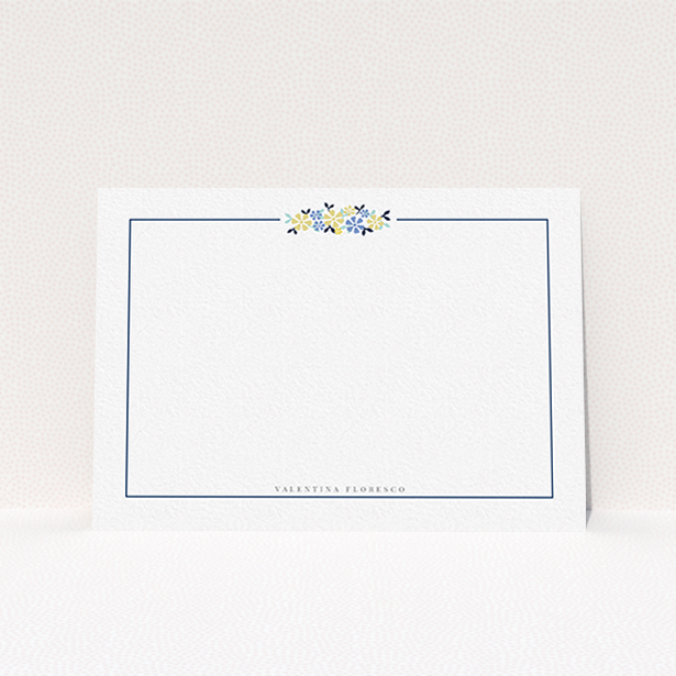 A ladies personalised note card design named "Surrounded by flowers". It is an A6 card in a landscape orientation. "Surrounded by flowers" is available as a flat card, with tones of white and blue.
