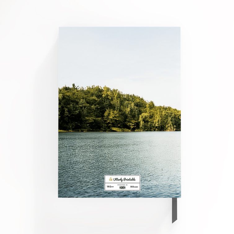 Portrait orientation notebook design with one photo of a couple jumping into a lake, showcasing a vibrant outdoor scene.