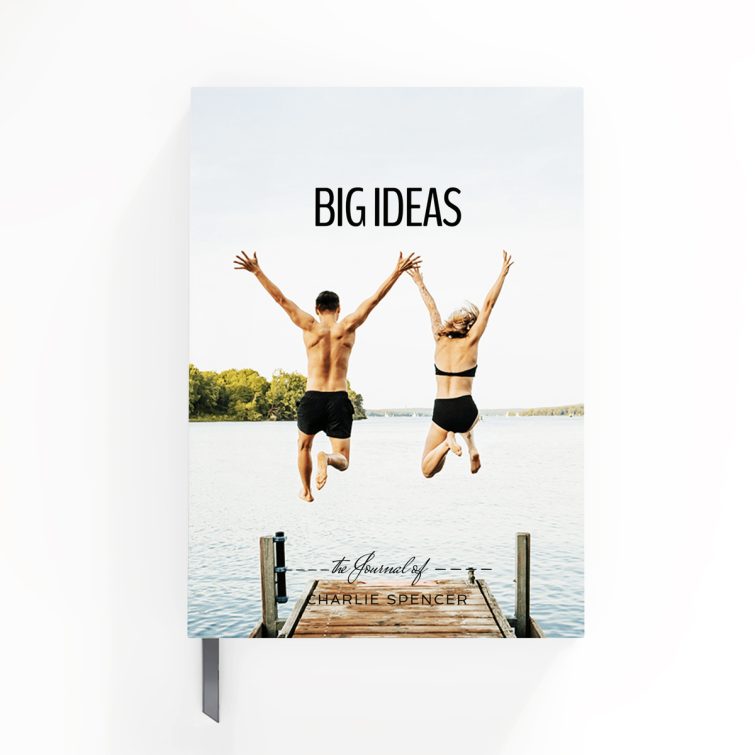 Portrait orientation notebook design with one photo of a couple jumping into a lake, showcasing a vibrant outdoor scene.