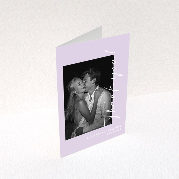 Wedding thank you card with a couple embracing and text details, one photo present